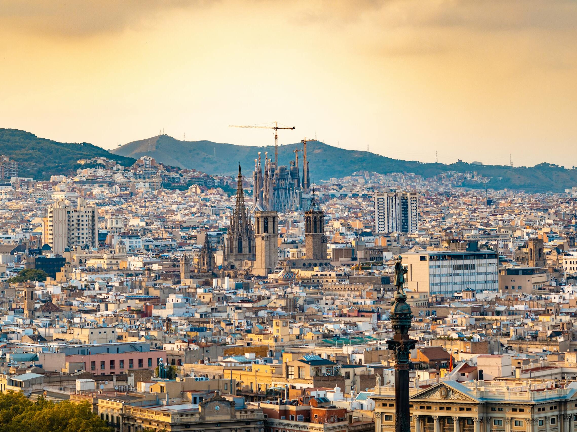 A breathtaking aerial view of Barcelona featuring the iconic Sagrada Familia at sunset.